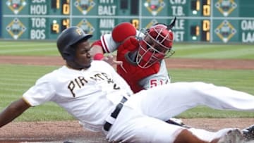 Jun 13, 2015; Pittsburgh, PA, USA; Pittsburgh Pirates right fielder Gregory Polanco (25) slides past Philadelphia Phillies catcher Carlos Ruiz (51) to score a run during the first inning at PNC Park. Mandatory Credit: Charles LeClaire-USA TODAY Sports