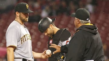 May 9, 2016; Cincinnati, OH, USA; Pittsburgh Pirates manager Clint Hurdle (right) takes the ball from starting pitcher Jonathon Niese (left) during the seventh inning against the Cincinnati Reds at Great American Ball Park. The Reds won 3-2. Mandatory Credit: David Kohl-USA TODAY Sports