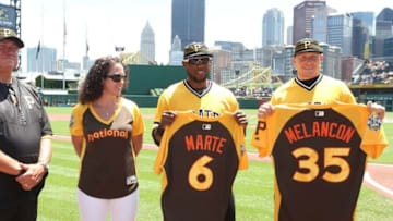 Jul 10, 2016; Pittsburgh, PA, USA; Pittsburgh Pirates manager Clint Hurdle (L) looks on as Majestic uniform representative Jennifer Bankhead (LC) presents left fielder Starling Marte (6) and relief pitcher Mark Melancon (35) with their All-Star game jerseys before the game against the Chicago Cubs at PNC Park. Mandatory Credit: Charles LeClaire-USA TODAY Sports