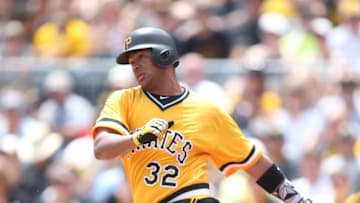 Jul 24, 2016; Pittsburgh, PA, USA; Pittsburgh Pirates catcher Elias Diaz (32) drives in a run against the Philadelphia Phillies during the second inning at PNC Park. Mandatory Credit: Charles LeClaire-USA TODAY Sports