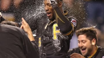 Oct 2, 2015; Pittsburgh, PA, USA; Pittsburgh Pirates left fielder Starling Marte (center) celebrates with teammates after hitting a two run game winning walk-off home run against the Cincinnati Reds during the twelfth inning at PNC Park. The Pirates won 6-4 in twelve innings. Mandatory Credit: Charles LeClaire-USA TODAY Sports