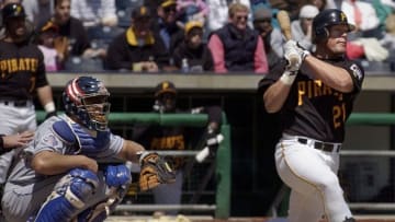 Pittsburgh Pirates' left fielder Brian Giles (R) hits a 2 RBI single off of Los Angeles Dodgers pitcher Hideo Nomo as Dodgers Catcher Chad Kreuter (L) watches during the third inning on 25 April, 2002 at PNC Park in Pittsburgh, PA. The Pirates defeated the Dodgers 3-2. AFP Photo/David Maxwell (Photo by David MAXWELL / AFP) (Photo credit should read DAVID MAXWELL/AFP via Getty Images)