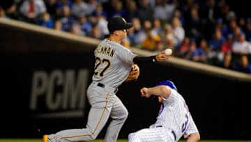 CHICAGO, IL - SEPTEMBER 25: Kevin Newman #27 of the Pittsburgh Pirates throws to first base after forcing out Daniel Murphy #3 of the Chicago Cubs during the first inning at Wrigley Field on September 25, 2018 in Chicago, Illinois. (Photo by Jon Durr/Getty Images)