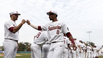 TALLAHASSEE, FL - FEBRUARY 15: Third Baseman Drew Mendoza #22 and Outfielder J.C. Flowers #8 of the Florida State Seminoles exchange hand shakes during the team's intro before the game against the Maine Black Bears at Dick Howser Stadium on the campus of Florida State University on February 15, 2019 in Tallahassee, Florida. The 11th Ranked Florida State defeated the Maine Black Bears on Opening Day in a no-hitter 11 to 0. (Photo by Don Juan Moore/Getty Images)