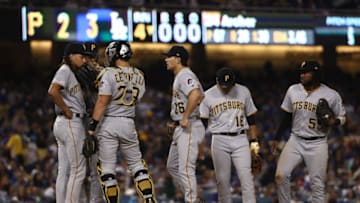 LOS ANGELES, CALIFORNIA - APRIL 26: Pitcher Chris Archer #24 of the Pittsburgh Pirates (L) is visited by teammates at the mound after Archer walked Max Muncy #13 of the Los Angeles Dodgers (not in photo) in the fourth inning during the MLB game at Dodger Stadium on April 26, 2019 in Los Angeles, California. The Dodgers defeated the Pirates 6-2. (Photo by Victor Decolongon/Getty Images)