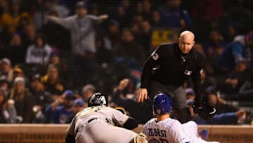 CHICAGO, ILLINOIS - APRIL 11: Ben Zobrist #18 of the Chicago Cubs is tagged out at home plate by by Francisco Cervelli #29 of the Pittsburgh Pirates during the sixth inning at Wrigley Field on April 11, 2019 in Chicago, Illinois. (Photo by Stacy Revere/Getty Images)