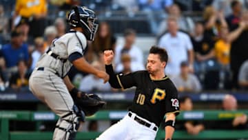 PITTSBURGH, PA - JUNE 21: Bryan Reynolds #10 of the Pittsburgh Pirates scores in front of Francisco Mejia #27 of the San Diego Padres during the first inning at PNC Park on June 21, 2019 in Pittsburgh, Pennsylvania. (Photo by Joe Sargent/Getty Images)
