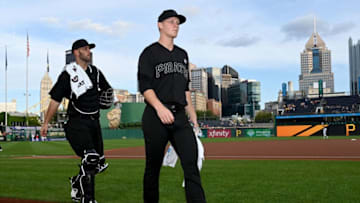 PITTSBURGH, PA - AUGUST 23: Mitch Keller #23 of the Pittsburgh Pirates walks to the dugout with Jacob Stallings #58 before the game against the Cincinnati Reds at PNC Park on August 23, 2019 in Pittsburgh, Pennsylvania. Teams are wearing special color schemed uniforms with players choosing nicknames to display for Players' Weekend. (Photo by Justin Berl/Getty Images)