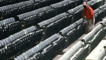 SARASOTA, FLORIDA - MARCH 15: General view of a stadium employee disinfecting the seats prior to the game between the Pittsburgh Pirates and the Baltimore Orioles during a spring training game at Ed Smith Stadium on March 15, 2021 in Sarasota, Florida. (Photo by Douglas P. DeFelice/Getty Images)