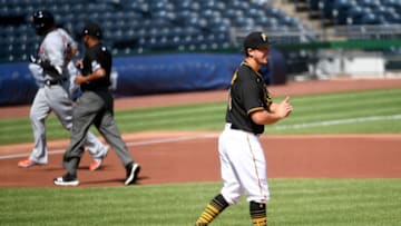 PITTSBURGH, PA - AUGUST 08: Derek Holland #45 of the Pittsburgh Pirates reacts as C.J. Cron #26 of the Detroit Tigers rounds the bases after hitting a solo home run in the first inning during the game at PNC Park on August 8, 2020 in Pittsburgh, Pennsylvania. (Photo by Justin Berl/Getty Images)