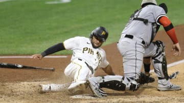 Sep 6, 2020; Pittsburgh, Pennsylvania, USA; Pittsburgh Pirates pinch runner Jason Martin (51) scores the game winning run behind Chicago White Sox catcher Yasmani Grandal (24) during the ninth inning at PNC Park. Grandal dropped the ball on the play for an error. The Pirates won 5-4. Mandatory Credit: Charles LeClaire-USA TODAY Sports