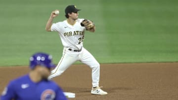 Sep 22, 2020; Pittsburgh, Pennsylvania, USA; Pittsburgh Pirates second baseman Adam Frazier (26) throws to first base to complete a double play against the Chicago Cubs during the fourth inning at PNC Park. Mandatory Credit: Charles LeClaire-USA TODAY Sports