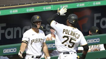 Apr 8, 2021; Pittsburgh, Pennsylvania, USA; Pittsburgh Pirates right fielder Gregory Polanco (25) celebrates with second baseman Adam Frazier (26) after scoring a run against the Chicago Cubs during the fourth inning at PNC Park. Mandatory Credit: Charles LeClaire-USA TODAY Sports