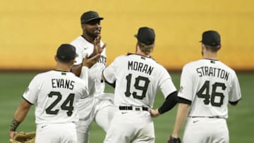 Apr 14, 2021; Pittsburgh, Pennsylvania, USA; Pittsburgh Pirates right fielder Gregory Polanco (top) celebrates with third baseman Phillip Evans (24), first baseman Colin Moran (19) and relief pitcher Chris Stratton (46) after defeating the San Diego Padres at PNC Park. Mandatory Credit: Charles LeClaire-USA TODAY Sports