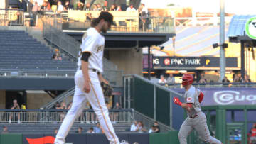 May 12, 2022; Pittsburgh, Pennsylvania, USA; Cincinnati Reds catcher Tyler Stephenson (right) circles the bases after hitting a solo home run against Pittsburgh Pirates starting pitcher JT Brubaker (left) during the fourth inning at PNC Park. Mandatory Credit: Charles LeClaire-USA TODAY Sports