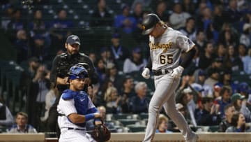 May 18, 2022; Chicago, Illinois, USA; Pittsburgh Pirates right fielder Jack Suwinski (65) crosses home plate after hitting a solo home run against the Chicago Cubs during the fifth inning at Wrigley Field. Mandatory Credit: Kamil Krzaczynski-USA TODAY Sports