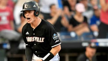 Louisville catcher Henry Davis (32) scores against Vanderbilt during the seventh inning of the 2019 NCAA Men's College World Series game at TD Ameritrade Park Friday, June 21, 2019, in Omaha, Neb.Vu Lou 062119 058