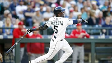 Aug 6, 2016; Seattle, WA, USA; Seattle Mariners left fielder Guillermo Heredia (5) follows through after hitting a solo home run against the Los Angeles Angels during the third inning at Safeco Field. Mandatory Credit: Jennifer Buchanan-USA TODAY Sports
