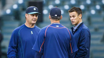 Apr 25, 2016; Seattle, WA, USA; Seattle Mariners manager Scott Servais (9, left) and general manager Jerry Dipoto talk with a member of the Houston Astros during batting practice at Safeco Field. Mandatory Credit: Joe Nicholson-USA TODAY Sports