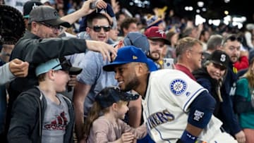 SEATTLE, WA - SEPTEMBER 30: Robinson Cano #22 of the Seattle Mariners hugs a young fan after a game against the Texas Rangers at Safeco Field on September 30, 2018 in Seattle, Washington. The Mariners won the game 3-1. (Photo by Stephen Brashear/Getty Images)