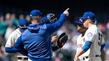 SEATTLE, WA - APRIL 28: Seattle Mariners manager Scott Servais (2L) signals to the bullpen as he pulls starting pitcher Erik Swanson #50 of the Seattle Mariners (R) during the fifth inning of a game against the Texas Rangers at T-Mobile Park on April 28, 2019 in Seattle, Washington. The Rangers won 14-1. (Photo by Stephen Brashear/Getty Images)