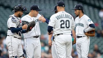SEATTLE, WA - JUNE 18: Starting pitcher Yusei Kikuchi #18 (second from left) of the Seattle Mariners meets at the mound with infielders including Omar Narvaez #22 of the Seattle Mariners J.P. Crawford #3 (right) and Daniel Vogelbach #20 (second from right) during the third inning of a game against the Kansas City Royals at T-Mobile Park on June 18, 2019 in Seattle, Washington. (Photo by Stephen Brashear/Getty Images)