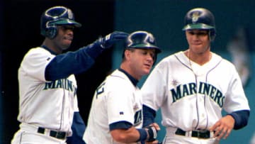 Seattle Mariners' Edgar Martinez(C) grimaces after he is congratulated by teammates Ken Griffey, Jr.(L) and Alex Rodriguez(R) after Martinez hit a first inning, three-run homer, against the New York Yankees in Seattle 26 May. Seattle defeated New York, 4-3. AFP PHOTO (Photo by DAN LEVINE / AFP) (Photo by DAN LEVINE/AFP via Getty Images)