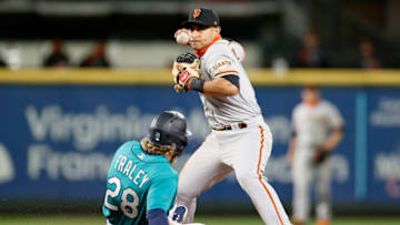 SEATTLE, WASHINGTON - APRIL 02: Donovan Solano #7 of the San Francisco Giants turns a double play over Jake Fraley #28 of the Seattle Mariners in the fourth inning at T-Mobile Park on April 02, 2021 in Seattle, Washington. (Photo by Steph Chambers/Getty Images)