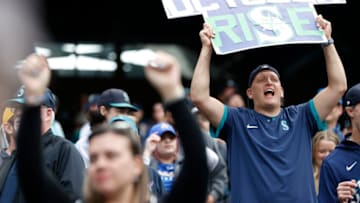 SEATTLE, WASHINGTON - OCTOBER 05: Fans hold signs during the ninth inning between the Seattle Mariners and the Detroit Tigers at T-Mobile Park on October 05, 2022 in Seattle, Washington. (Photo by Steph Chambers/Getty Images)