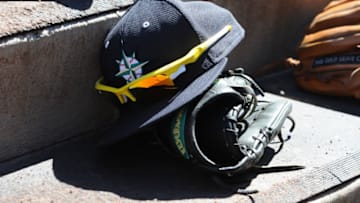 PEORIA, AZ - MARCH 4: A hat and glove of of the Seattle Mariners is seen prior to the game against the San Diego Padreson March 4, 2015 at Peoria Stadium in Peoria, Arizona. The Mariners defeated the Padres 4-3 in 10 innings. (Photo by Rich Pilling/Getty Images)