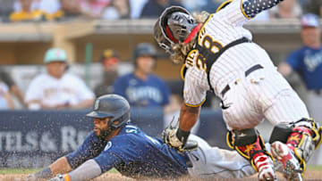 SAN DIEGO, CA - JULY 4: Carlos Santana #41 of the Seattle Mariners scores ahead of the tag of Jorge Alfaro #38 of the San Diego Padres during the eighth inning of a baseball game July 4, 2022 at Petco Park in San Diego, California. (Photo by Denis Poroy/Getty Images)
