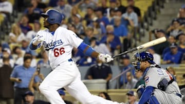 Oct 19, 2016; Los Angeles, CA, USA; Los Angeles Dodgers right fielder Yasiel Puig hits a single against the Chicago Cubs in the 9th inning during game four of the 2016 NLCS playoff baseball series at Dodger Stadium. Mandatory Credit: Richard Mackson-USA TODAY Sports