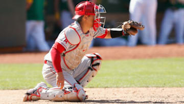OAKLAND, CALIFORNIA - MAY 30: Catcher Kurt Suzuki #24 of the Los Angeles Angels catches in the game against the Oakland Athletics at RingCentral Coliseum on May 30, 2021 in Oakland, California. (Photo by Lachlan Cunningham/Getty Images)