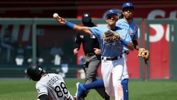 KANSAS CITY, MISSOURI - SEPTEMBER 05: Nicky Lopez #8 of the Kansas City Royals throws toward first on a double play attempt as Luis Robert #88 of the Chicago White Sox slides into second during the game at Kauffman Stadium on September 05, 2021 in Kansas City, Missouri. (Photo by Jamie Squire/Getty Images)
