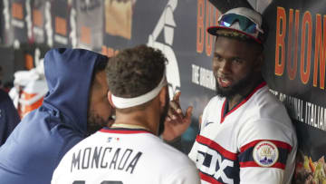 CHICAGO, ILLINOIS - OCTOBER 03: Luis Robert #88 of the Chicago White Sox talks with Jose Abreu #79 and Yoan Moncada during the fourth inning of a game against the Detroit Tigers at Guaranteed Rate Field on October 03, 2021 in Chicago, Illinois. (Photo by Nuccio DiNuzzo/Getty Images)