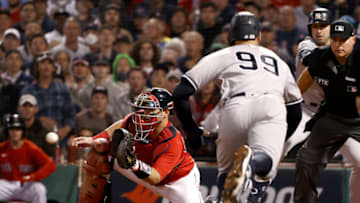 BOSTON, MASSACHUSETTS - OCTOBER 05: Aaron Judge #99 of the New York Yankees is tagged out by Kevin Plawecki #25 of the Boston Red Sox during the sixth inning of the American League Wild Card game at Fenway Park on October 05, 2021 in Boston, Massachusetts. (Photo by Winslow Townson/Getty Images)