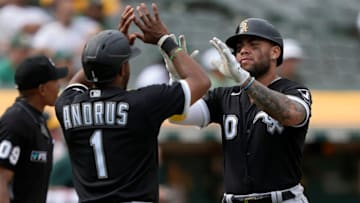 OAKLAND, CALIFORNIA - SEPTEMBER 10: Elvis Andrus #1 and Yoan Moncada #10 of the Chicago White Sox congratulated each other after they both scored on a two-run RBI single from Eloy Jimenez #74 against the Oakland Athletics in the top of the seventh inning at RingCentral Coliseum on September 10, 2022 in Oakland, California. The White Sox won the game 10-2. (Photo by Thearon W. Henderson/Getty Images)