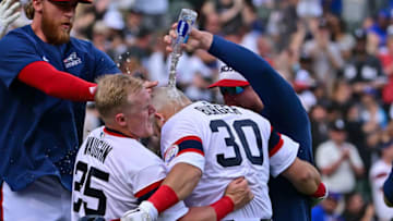 CHICAGO, ILLINOIS - MAY 29: Jake Burger #30 of the Chicago White Sox gets doused with water after his game-winning single in the 12th inning against the Chicago Cubs at Guaranteed Rate Field on May 29, 2022 in Chicago, Illinois. (Photo by Quinn Harris/Getty Images)