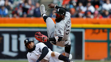Apr 8, 2022; Detroit, Michigan, USA; Chicago White Sox second baseman Josh Harrison (5) falls over Detroit Tigers third baseman Jeimer Candelario (46) after he makes a throw to first to complete a double play in the sixth inning at Comerica Park. Mandatory Credit: Rick Osentoski-USA TODAY Sports