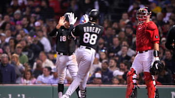 May 6, 2022; Boston, Massachusetts, USA; Chicago White Sox left fielder AJ Pollock (18) hi fives Chicago White Sox center fielder Luis Robert (88) for hitting a two run home run against the Boston Red Sox during the third inning at Fenway Park. Mandatory Credit: Gregory Fisher-USA TODAY Sports