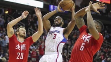 Feb 25, 2015; Houston, TX, USA; Los Angeles Clippers guard Chris Paul (3) attempts to score during the fourth quarter as Houston Rockets forward Donatas Motiejunas (20) and forward Terrence Jones (6) defend at Toyota Center. The Rockets defeated the Clippers 110-105. Mandatory Credit: Troy Taormina-USA TODAY Sports