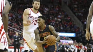 Dec 29, 2015; Houston, TX, USA; Atlanta Hawks guard Jeff Teague (0) moves the ball during the second quarter as Houston Rockets forward Donatas Motiejunas (20) defends at Toyota Center. Mandatory Credit: Troy Taormina-USA TODAY Sports