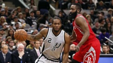Jan 2, 2016; San Antonio, TX, USA; San Antonio Spurs small forward Kawhi Leonard (2) drives against Houston Rockets shooting guard James Harden (R) during the first half at AT&T Center. Mandatory Credit: Soobum Im-USA TODAY Sports