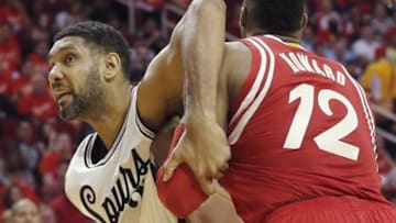 Dec 25, 2015; Houston, TX, USA; San Antonio Spurs center Tim Duncan (21) and Houston Rockets center Dwight Howard (12) fight for position in the second half of a NBA basketball game on Christmas at Toyota Center. Rockets won 88 to 84. Mandatory Credit: Thomas B. Shea-USA TODAY Sports