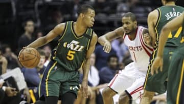 Apr 15, 2015; Houston, TX, USA; Utah Jazz guard Rodney Hood (5) moves the ball during the third quarter as Houston Rockets forward Trevor Ariza (1) defends at Toyota Center. Mandatory Credit: Troy Taormina-USA TODAY Sports