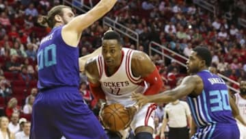 Dec 21, 2015; Houston, TX, USA; Houston Rockets center Dwight Howard (12) prepares to shoot the ball between Charlotte Hornets forward Spencer Hawes (00) and guard Troy Daniels (30) during the second quarter at Toyota Center. Mandatory Credit: Troy Taormina-USA TODAY Sports