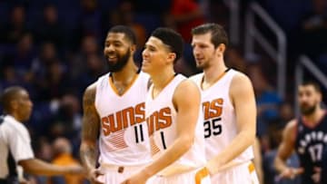Feb 2, 2016; Phoenix, AZ, USA; Phoenix Suns guard Devin Booker (1) celebrates a play with forward Markieff Morris (11) and forward Mirza Teletovic (35) in the second quarter against the Toronto Raptors at Talking Stick Resort Arena. Mandatory Credit: Mark J. Rebilas-USA TODAY Sports
