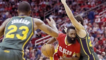 Jan 7, 2016; Houston, TX, USA; Houston Rockets guard James Harden (13) drives as he splits the defense of Utah Jazz forward Chris Johnson (23) and guard Raul Neto (25) in the second half at Toyota Center. Rockets won 103 to 94. Mandatory Credit: Thomas B. Shea-USA TODAY Sports