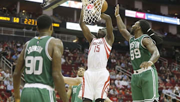 Nov 16, 2015; Houston, TX, USA; Houston Rockets center Clint Capela (15) shoots against Boston Celtics forward Jae Crowder (99) and forward Amir Johnson (90) in the second half at Toyota Center. Celtics won 111 to 95. Mandatory Credit: Thomas B. Shea-USA TODAY Sports