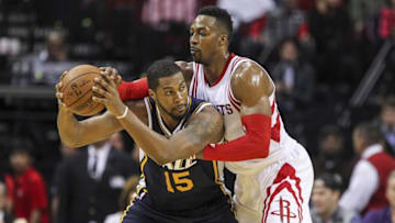 Mar 23, 2016; Houston, TX, USA; Utah Jazz forward Derrick Favors (15) controls the ball as Houston Rockets center Dwight Howard (12) defends during the second half at Toyota Center. The Jazz won 89-87. Mandatory Credit: Troy Taormina-USA TODAY Sports